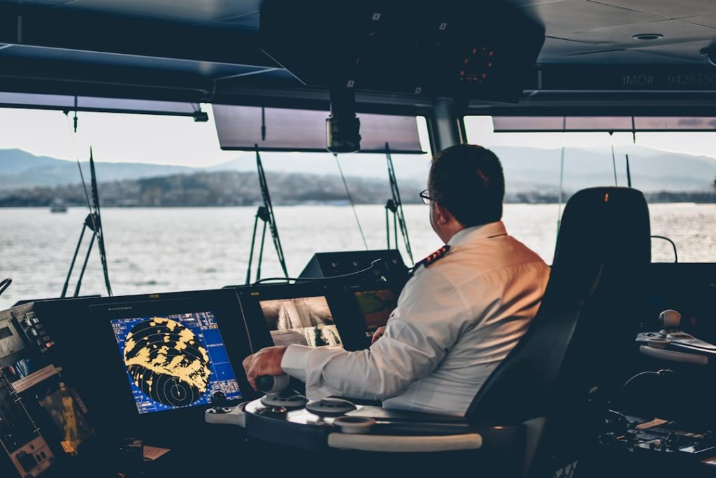 A captain controlling a cruise ferry from the cockpit in the afternoon.